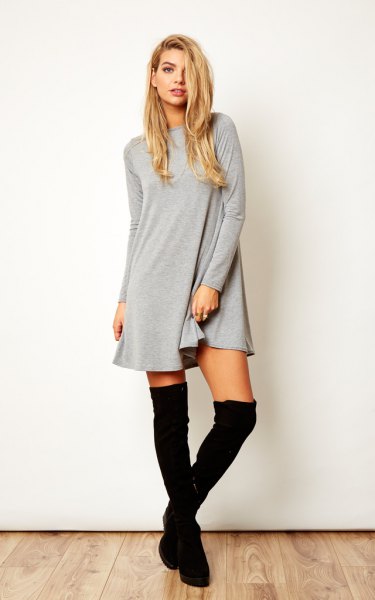 gray long sleeve swing dress with black thigh high boots