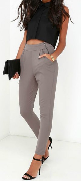 black sleeveless cropped blouse with gray skinny trousers