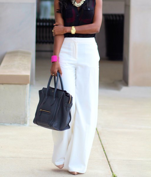 white trousers with black sleeveless blouse and statement necklace
