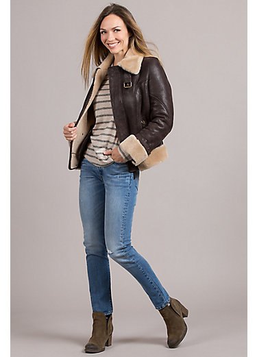 black shearling bomber jacket with striped tee and boots