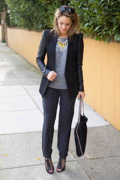 black blazer with gray sweater and polka dot silk trousers