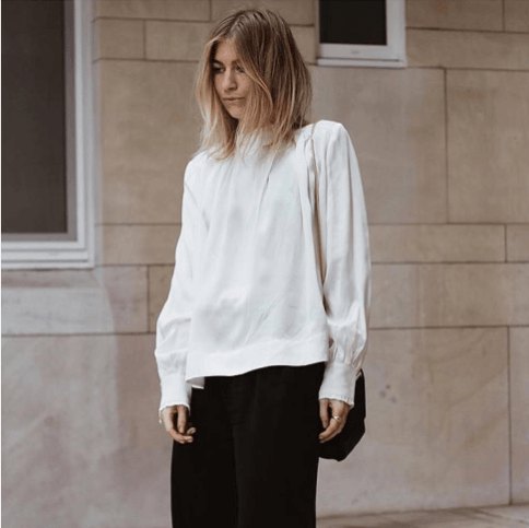 white long-sleeved blouse with black trousers of wide leg