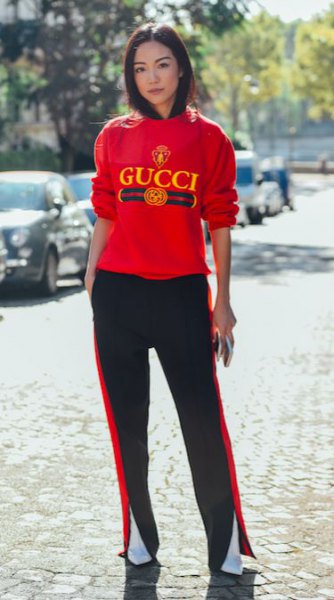 red sweater with black running pants