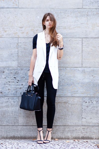 white sleeveless blazer with all black outfit