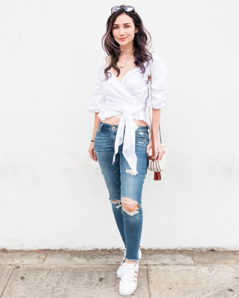 white cropped wrap blouse with ripped skinny jeans