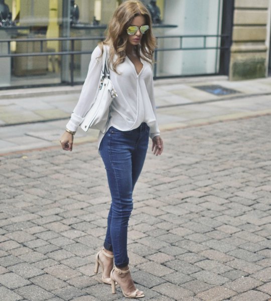 white wrap blouse with blue jeans and pink heels
