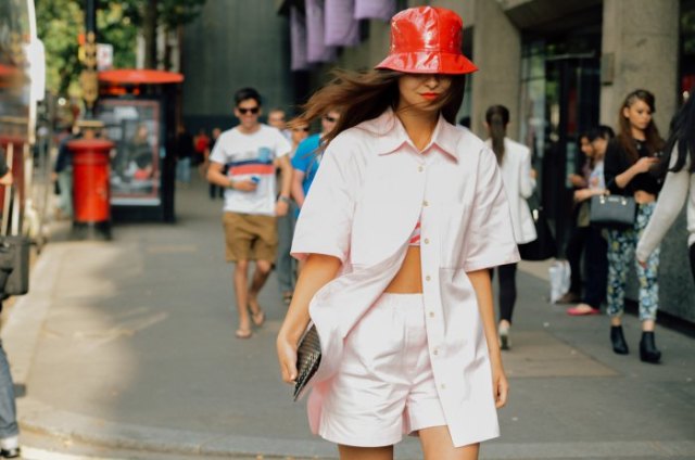 red leather hat with light pink oversized shirt and shorts