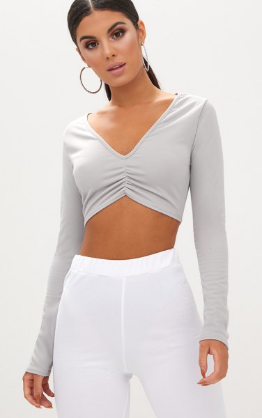 gray v-neck long sleeve crop top white elastic cotton trousers at the waist
