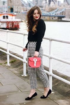 black sweater checkered pants red purse