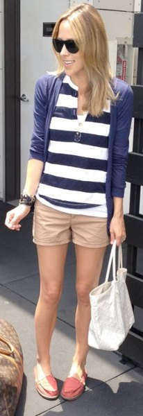 beige khaki shorts with navy and white striped polo shirt