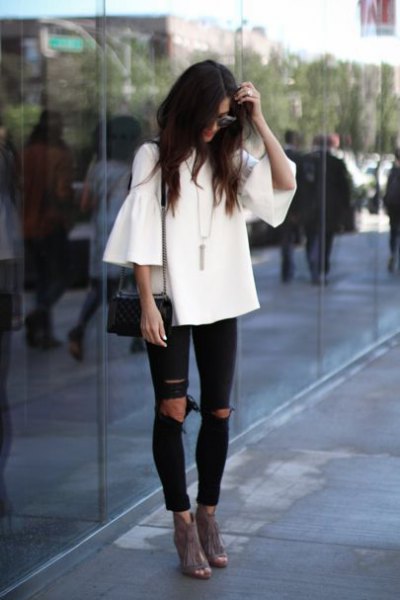 white woven ruffle top black ripped jeans