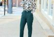 Great green outfit with dark green pants and floral dressy blouse .