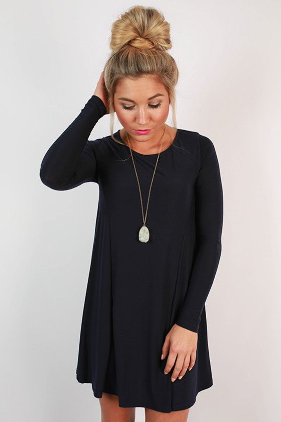 This simple shift dress is so chic! Wear it with a statement .