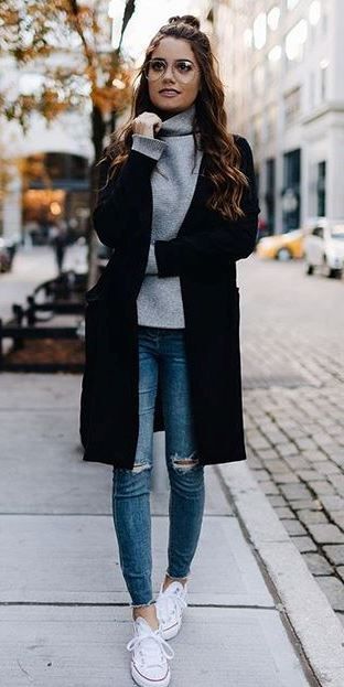 trendy outfit idea : black coat + sweater + rips + sneakers .