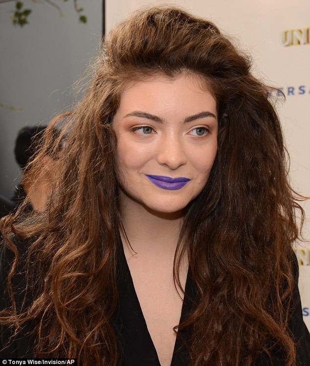 Lorde wears garish purple lipstick to pre-Grammy Awards brunch .