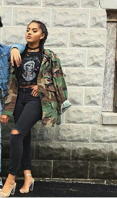 Tough looking. Love the braids with the camo jacket, black graphic .
