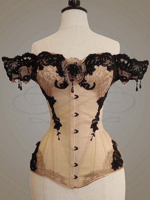 Ornate Victorian style black and white corset, draped lace sleeve .